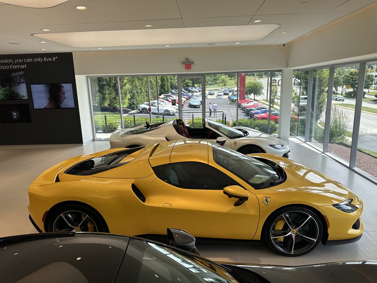 Yellow Ferrari at a dealership showroom